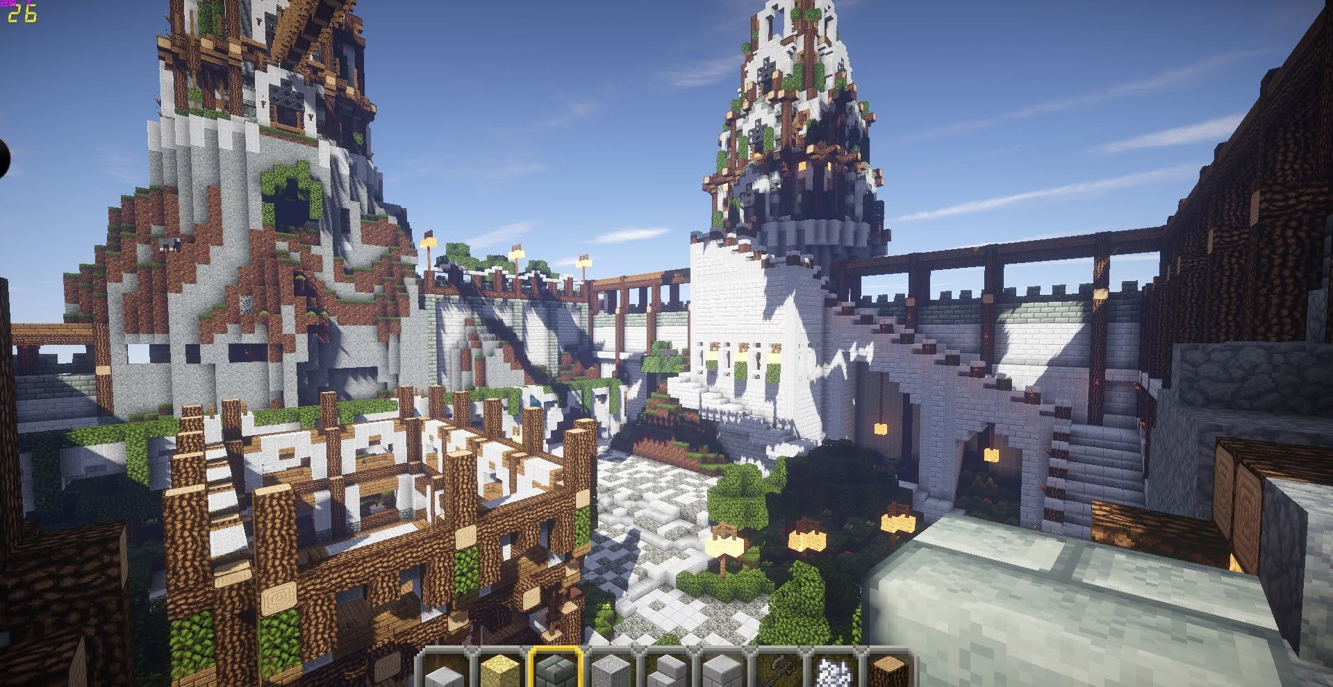 A walled CraftSerenity town with mountain spires, gardens and bridges in daylight