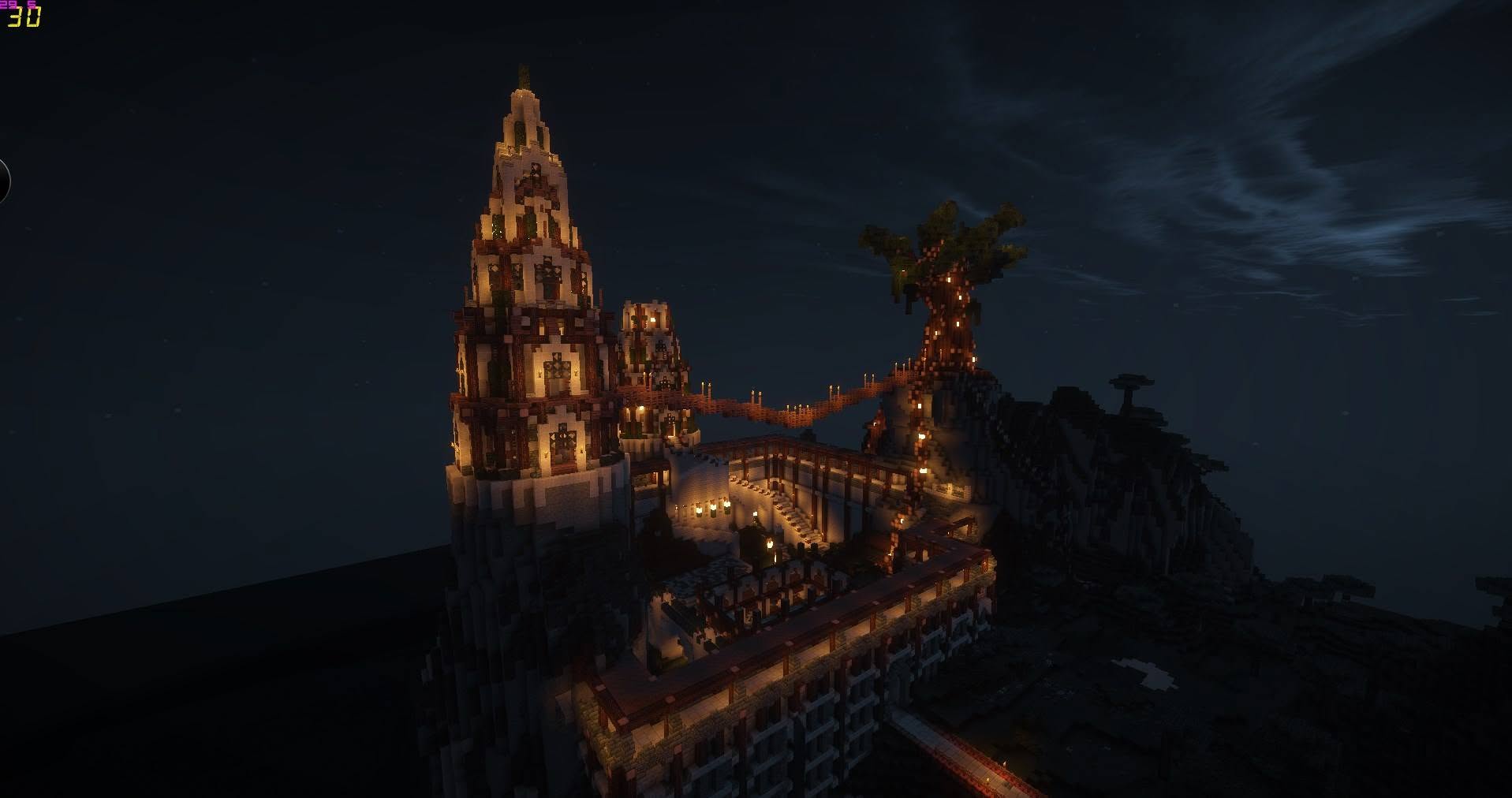 A lantern-lit spire and treehouse on CraftSerenity at night, joined by a rope bridge